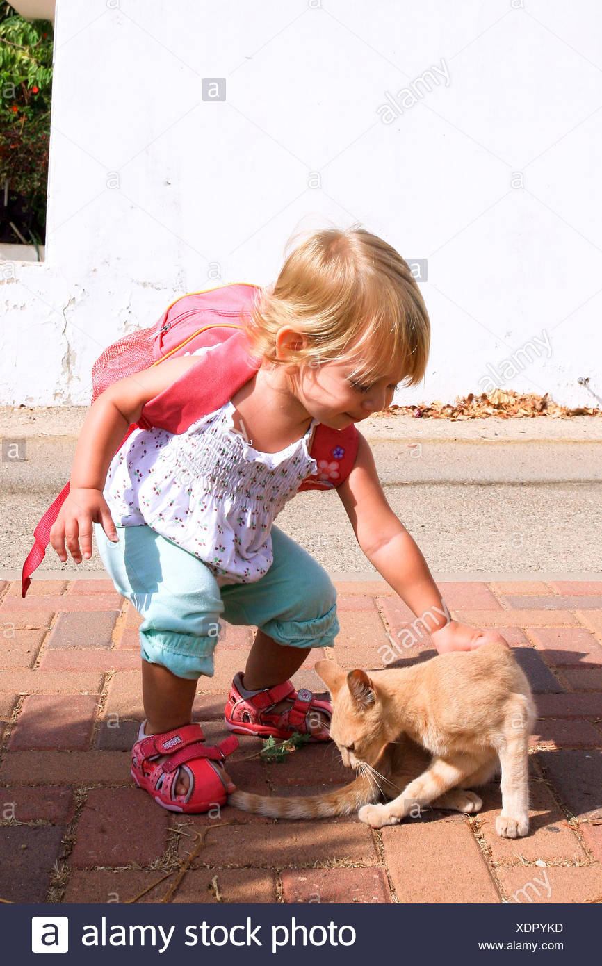 A 18 Month Toddler Girl With A Small Lunch Pack Ready For Kindergarten Saying Goodbye To Her Cat Stock Photo Alamy