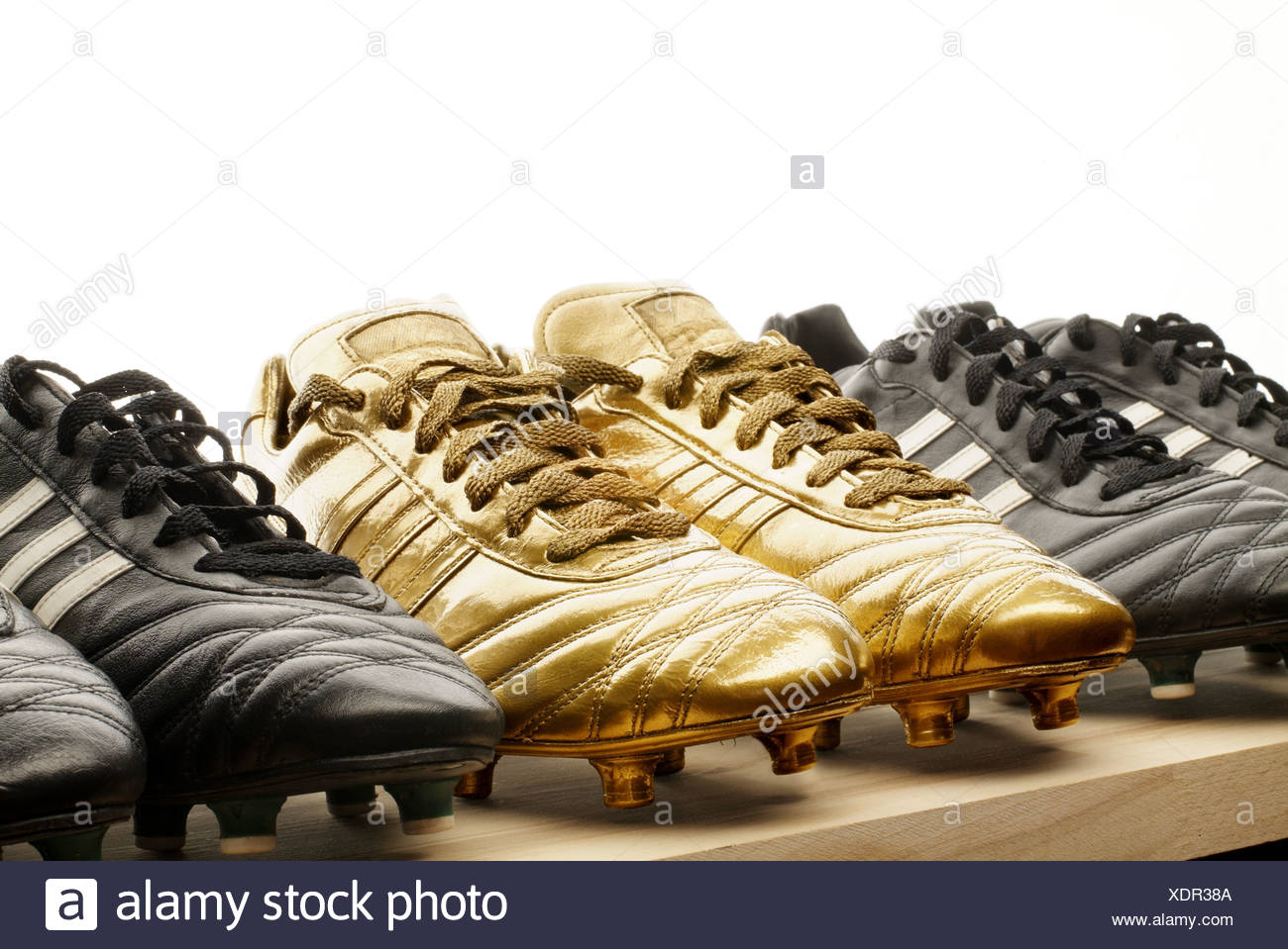 black and gold football boots