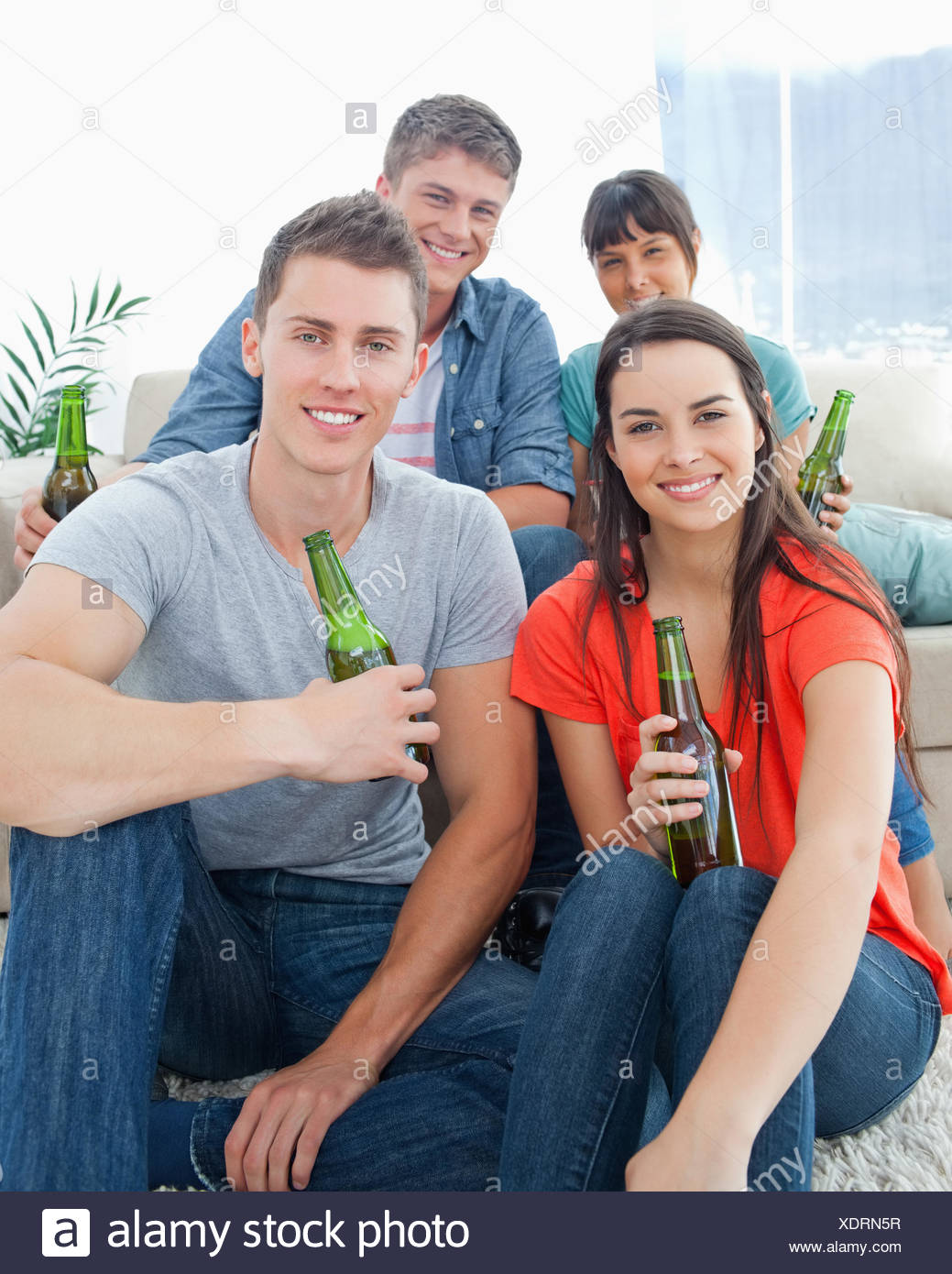 Two People Sitting On The Couch With The Other Two Sitting On The