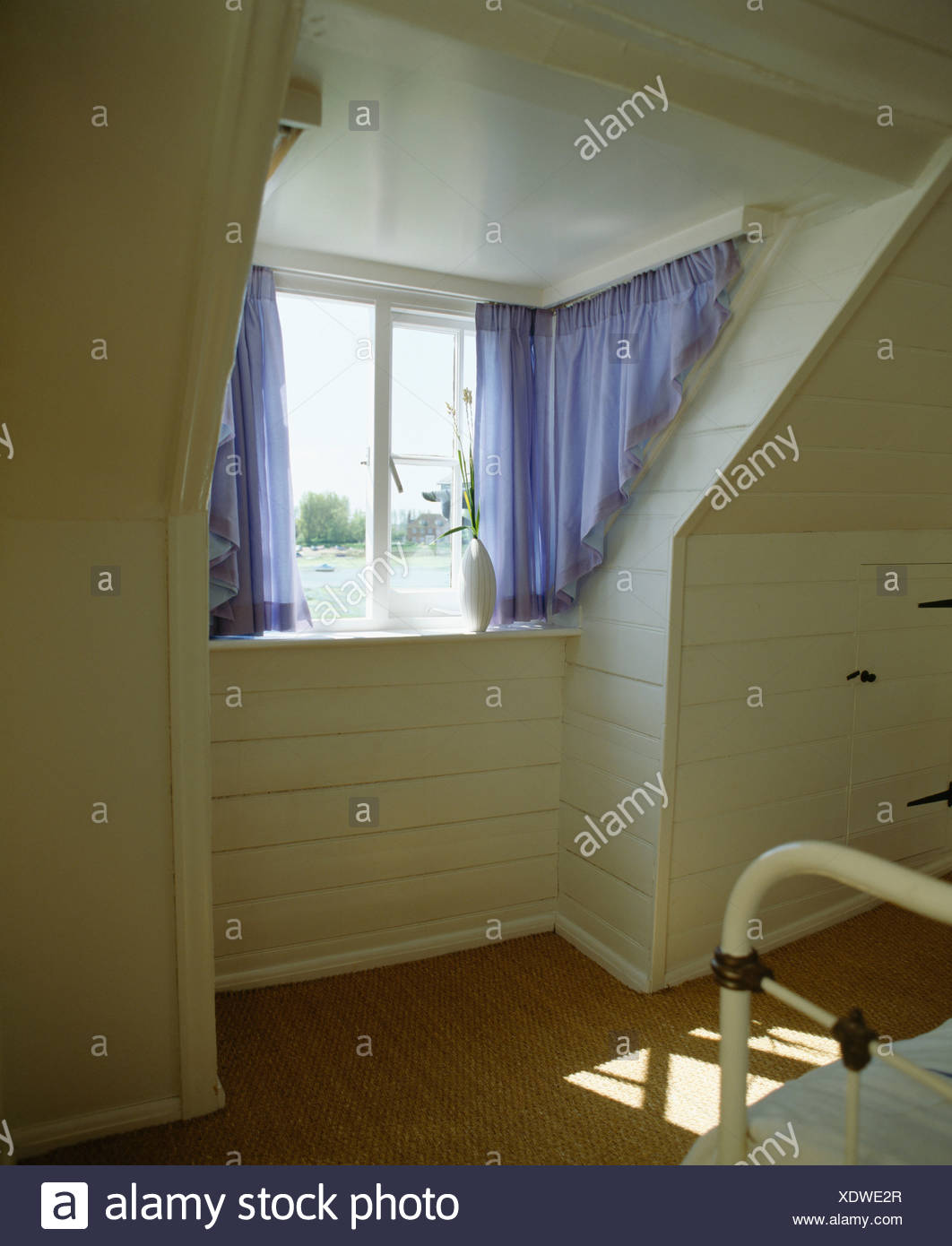 Blue Curtains On Portiere Rods On Awkwardly Shaped Dormer Window