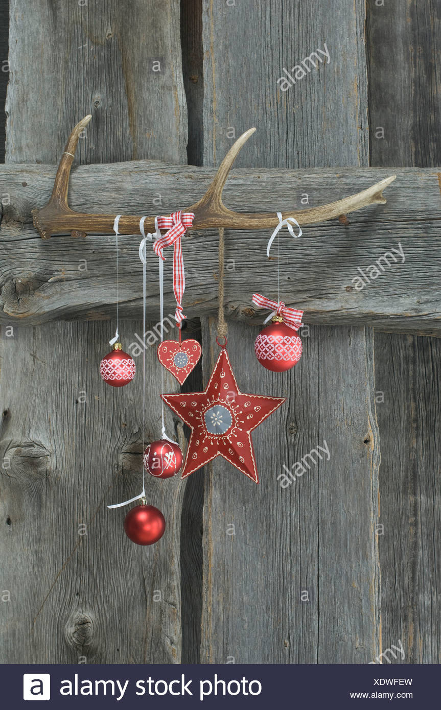Deer Antler And Christmas Decoration On Wooden Wall Stock Photo