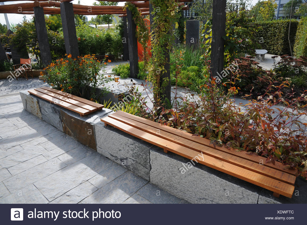 Garden With Bench Made Of Stone And Wood Stock Photo 283917660
