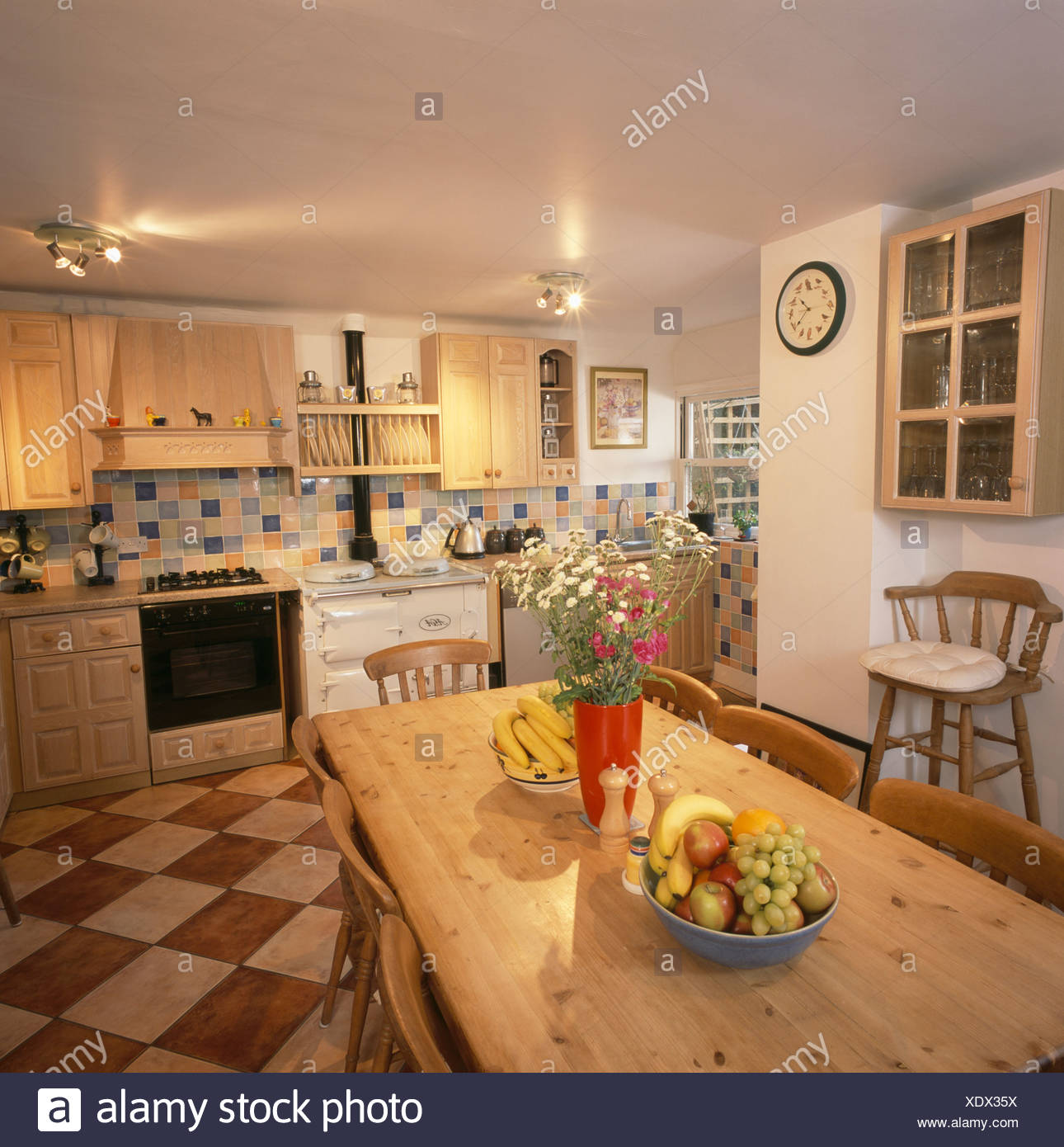 Ceiling Lights And Old Pine Table And Chairs In Country Kitchen