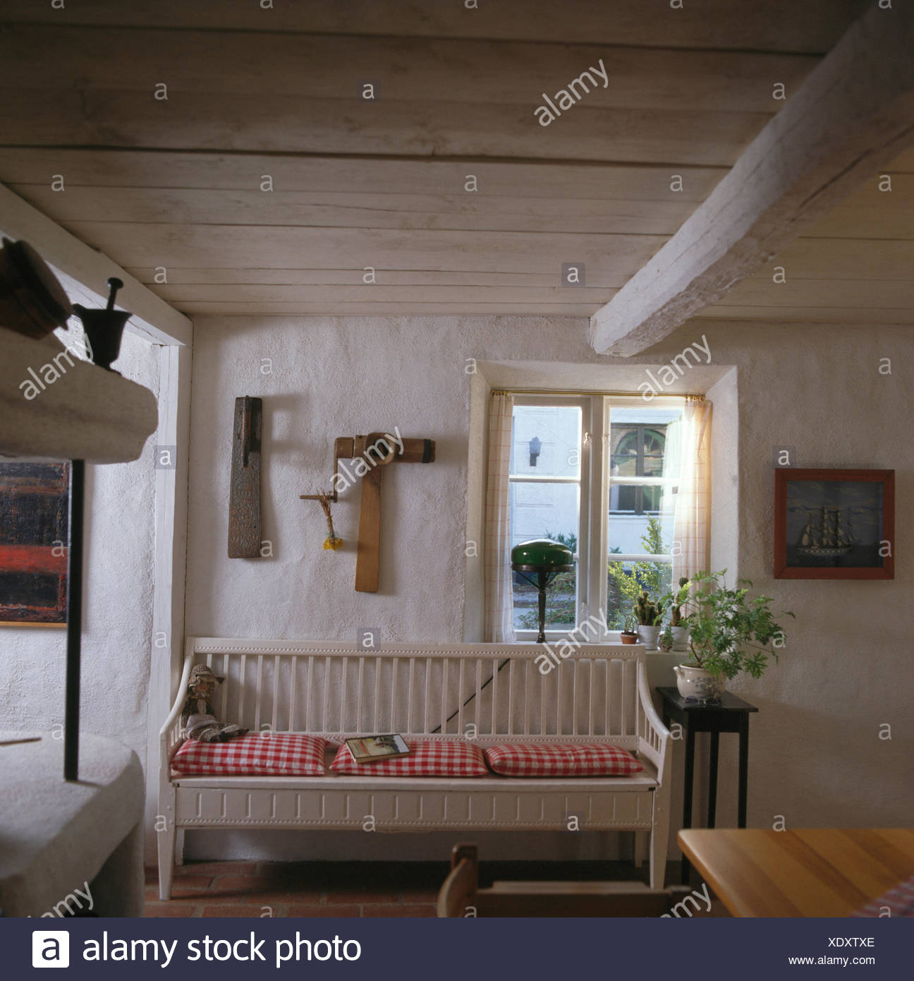 Red Checked Cushions On Painted Settle In Front Of Window White