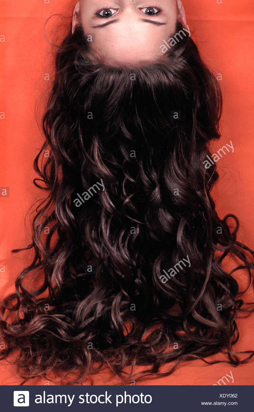 Female Upside Down With Long Curly Brunette Hair Hanging Down