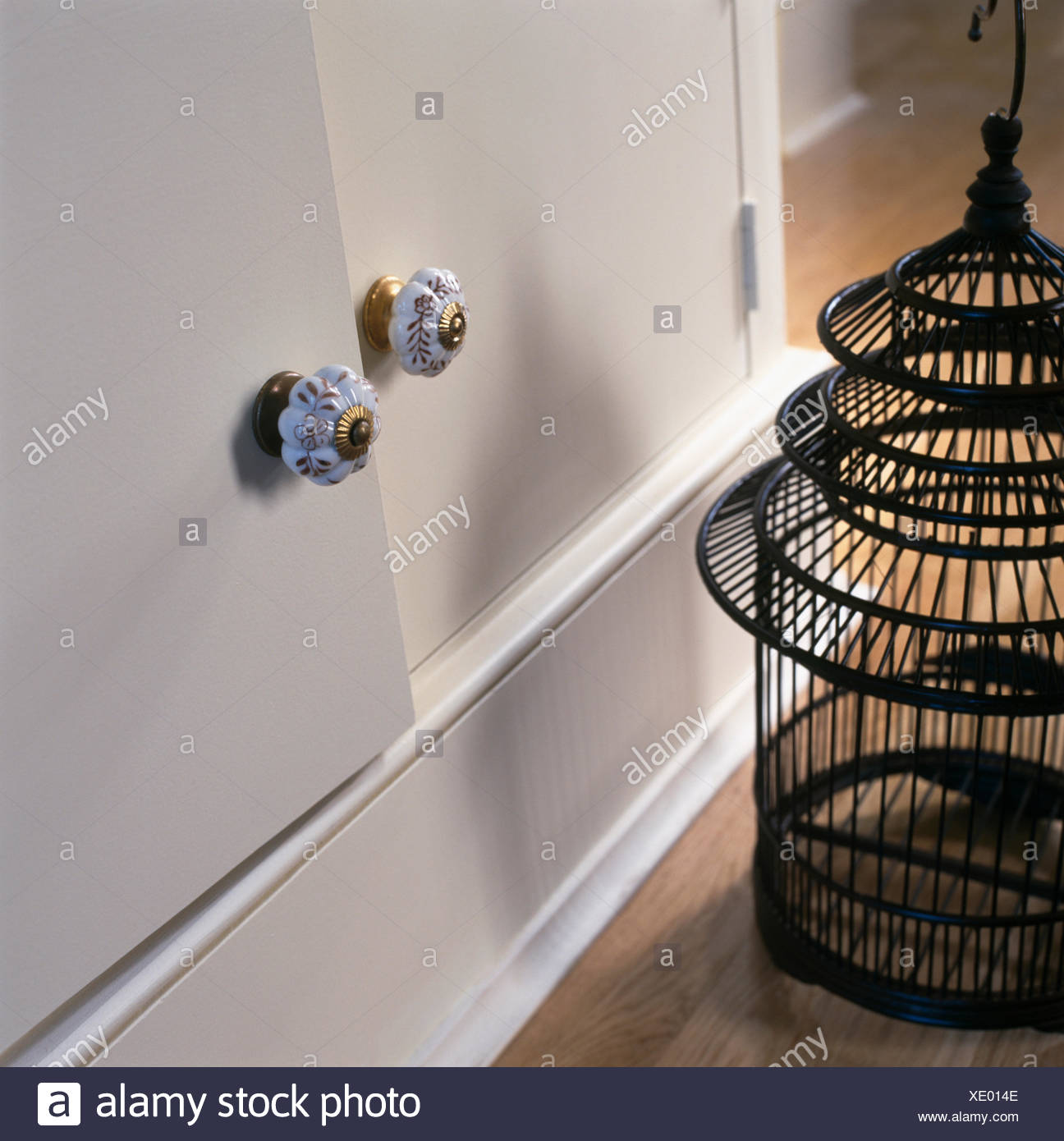 Close Up Of Decorative China Handles On White Cupboard Beside