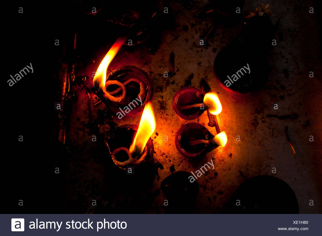 Burning oil lamps in an Indian temple Stock Photo