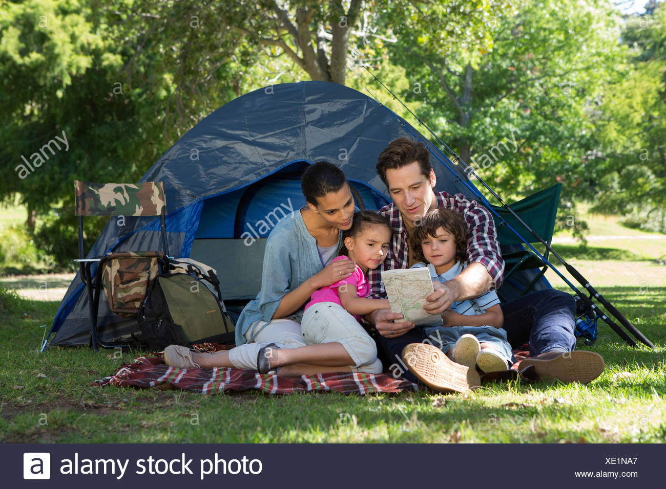 Happy Family On A Camping Trip In Their Tent Stock Photo Alamy