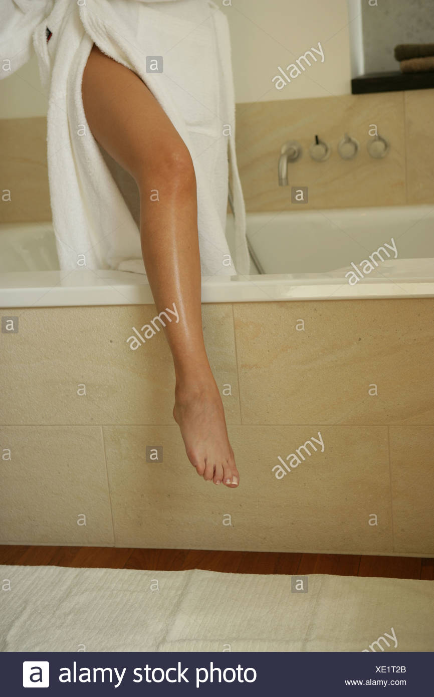 Leg Of A Woman Moving Out Of Her Bathtub Stock Photo