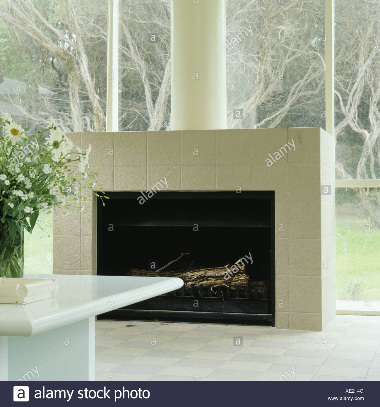 White Matt Tiled Fireplace In Glass Wall Of Modern Dining Room