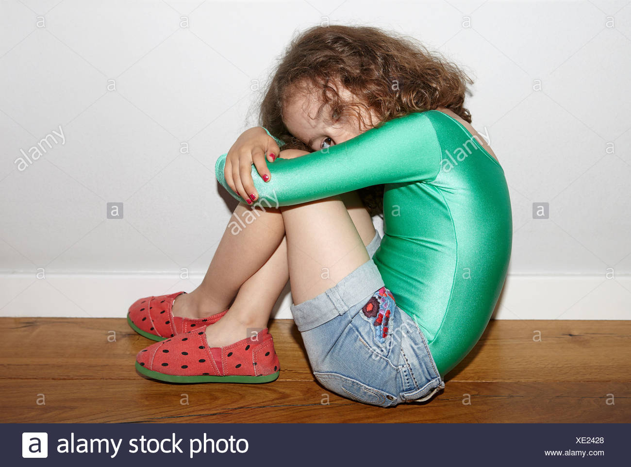 Sitting On Floor With Knees Bent Stock Photos & Sitting On Floor With