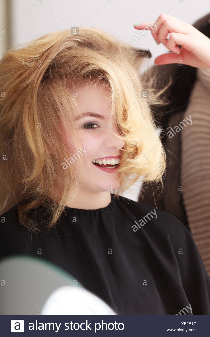 Beautiful Smiling Girl With Blond Wavy Hair By Hairdresser