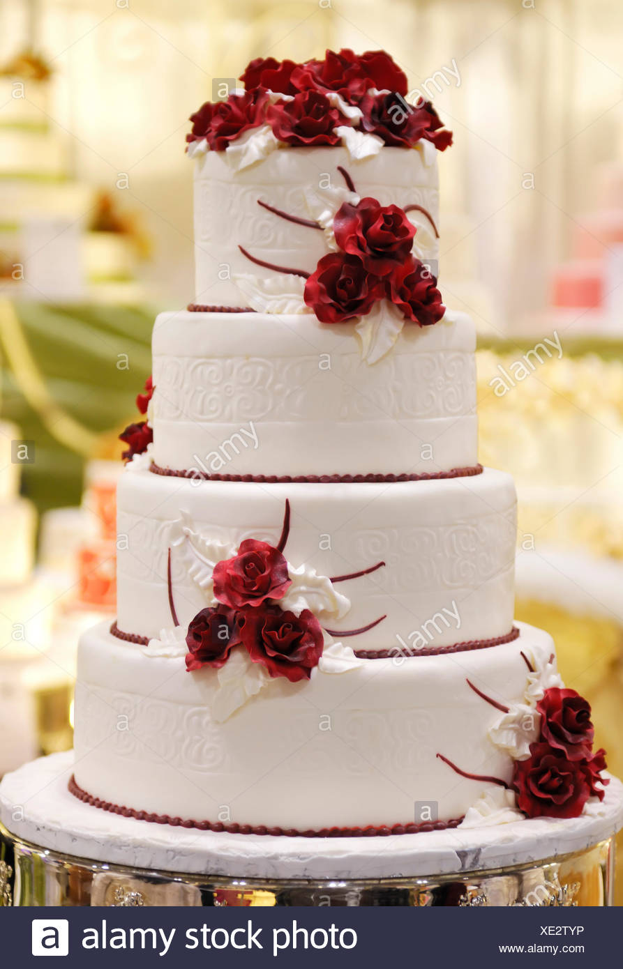 Tiered Wedding Cake Decorated With Red Roses Stock Photo
