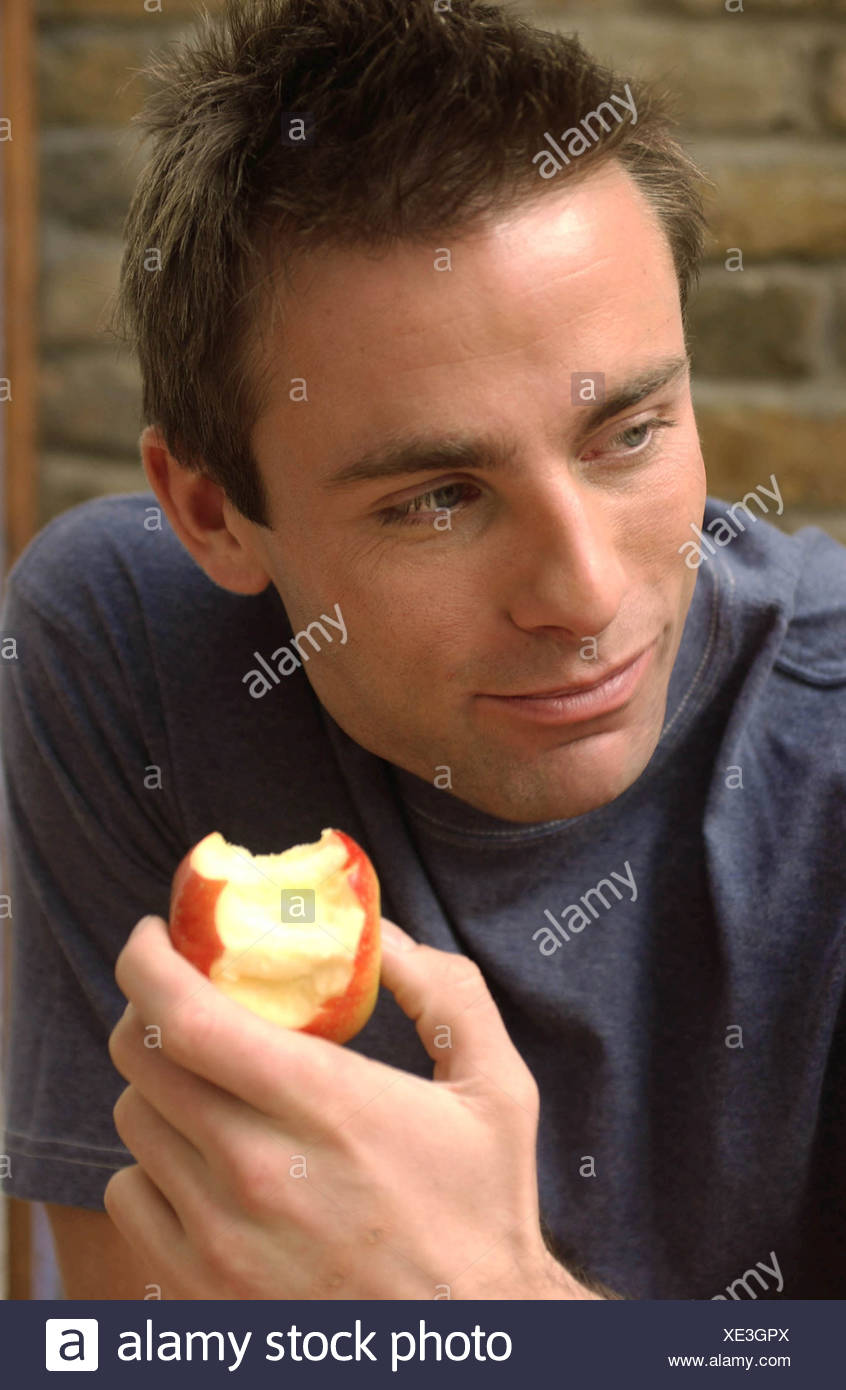 Male Short Brown Hair Wearing Dark Blue Sweatshirt Holding Half