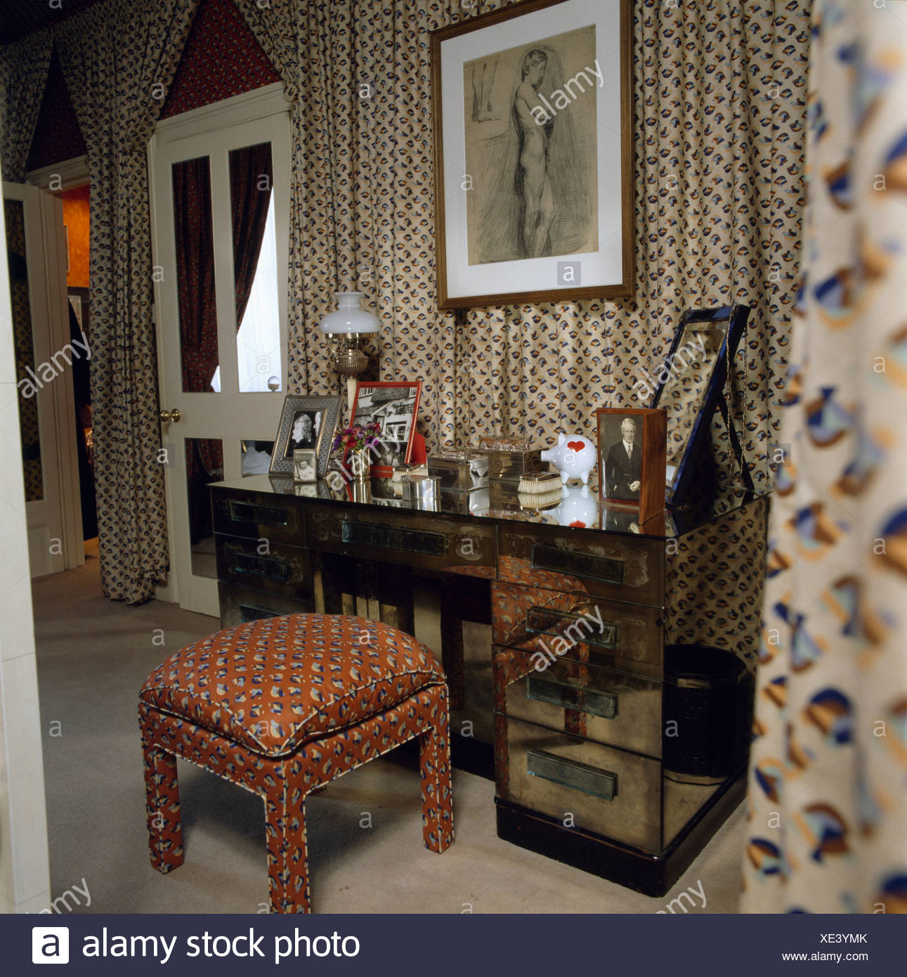 Mirrored Chest Of Drawers In Front Of Draped Fabric On Walls Of