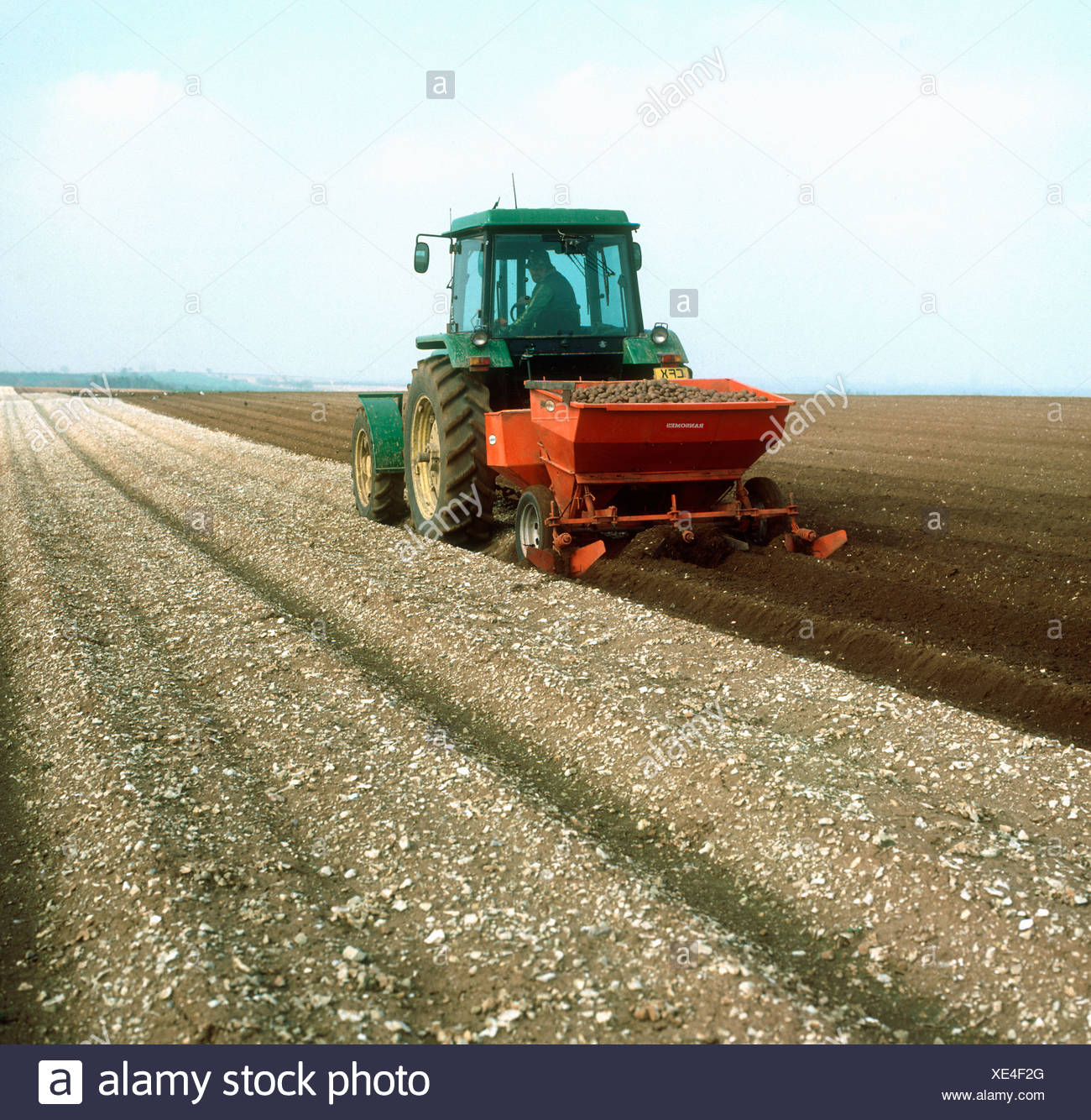 John Deere Tractor With Two Row Potato Planter Working On A Stony Chalkland Soil Stock Photo Alamy