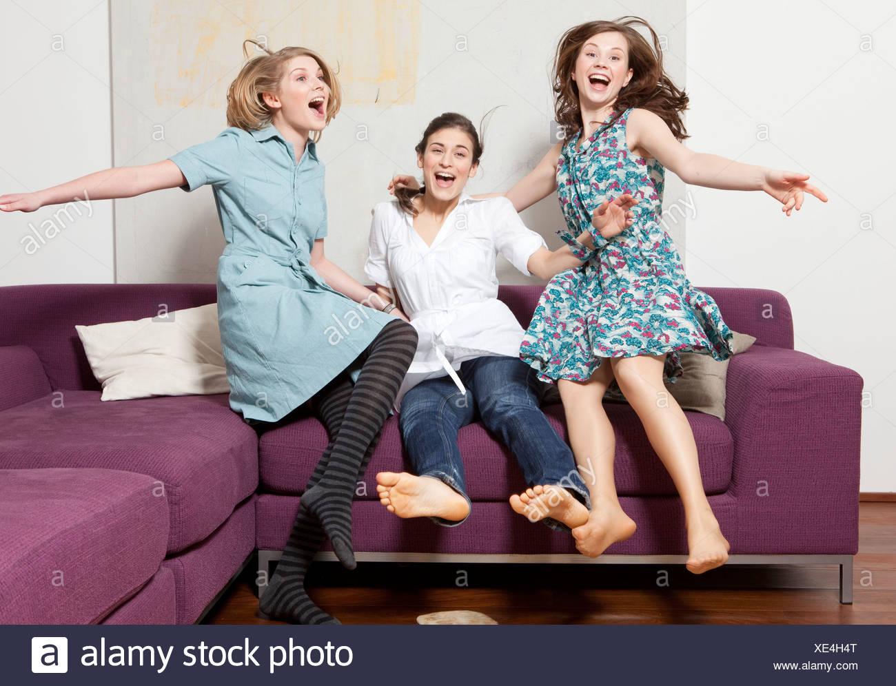 Three women jumping and jubilating Stock Photo