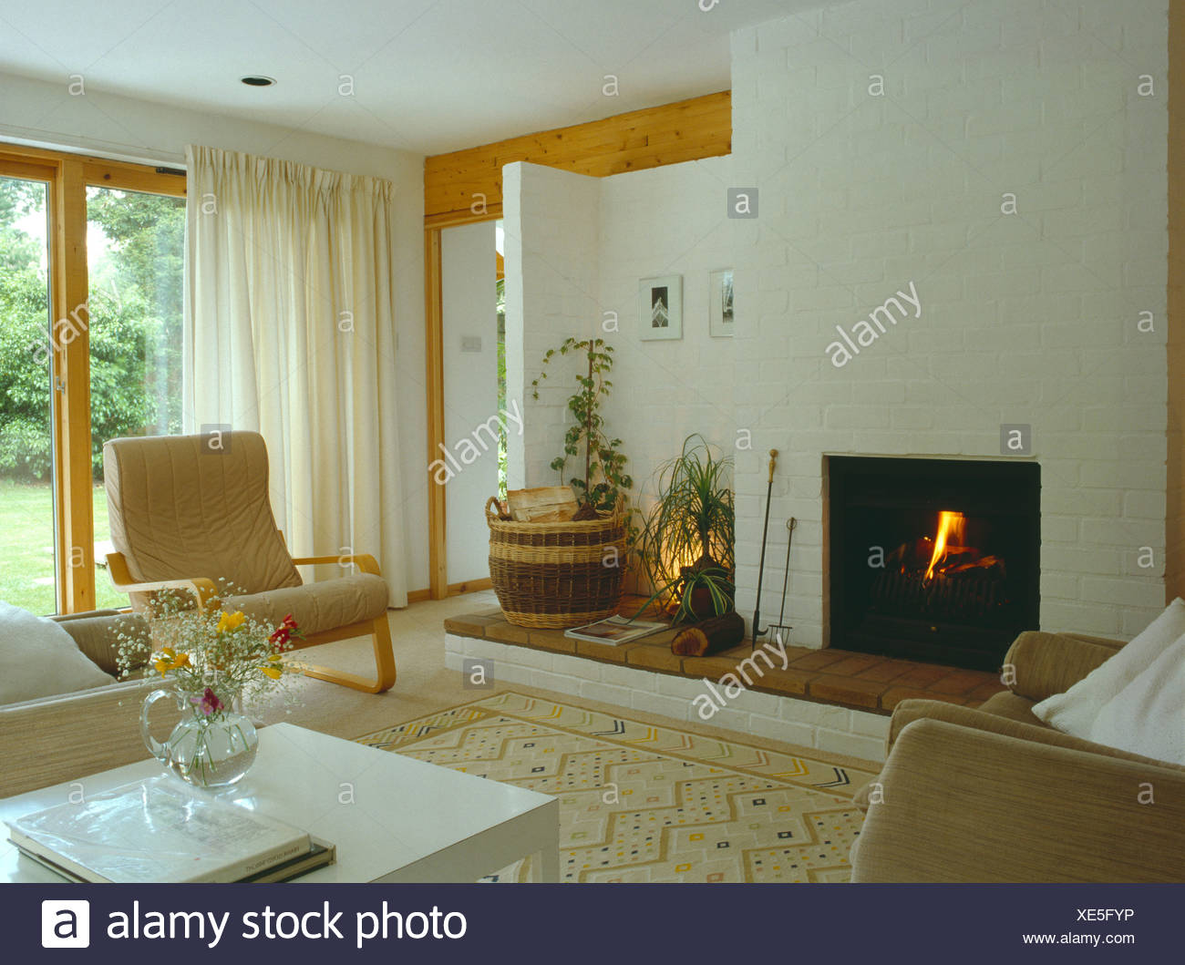 Lighted Fire And White Curtains In Modern Living Room With