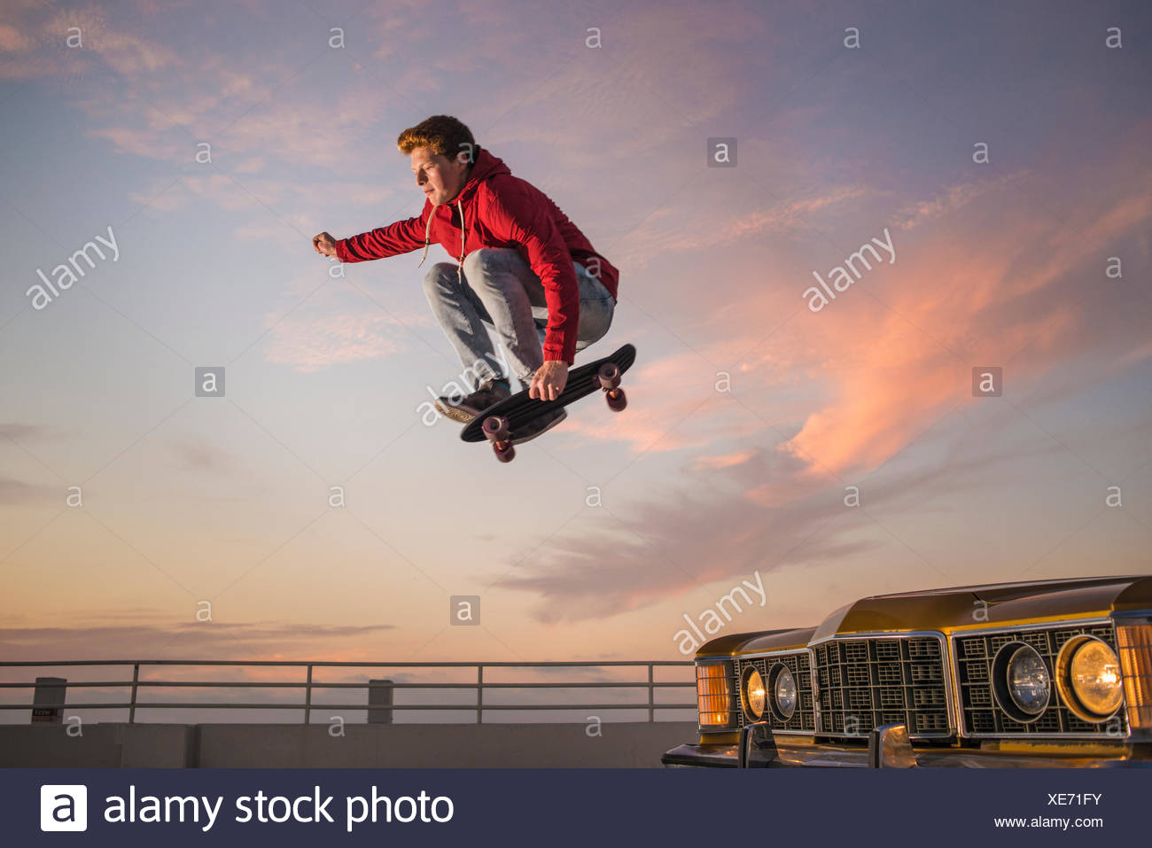 Portrait of young man on skateboard in mid air Stock Photo ...