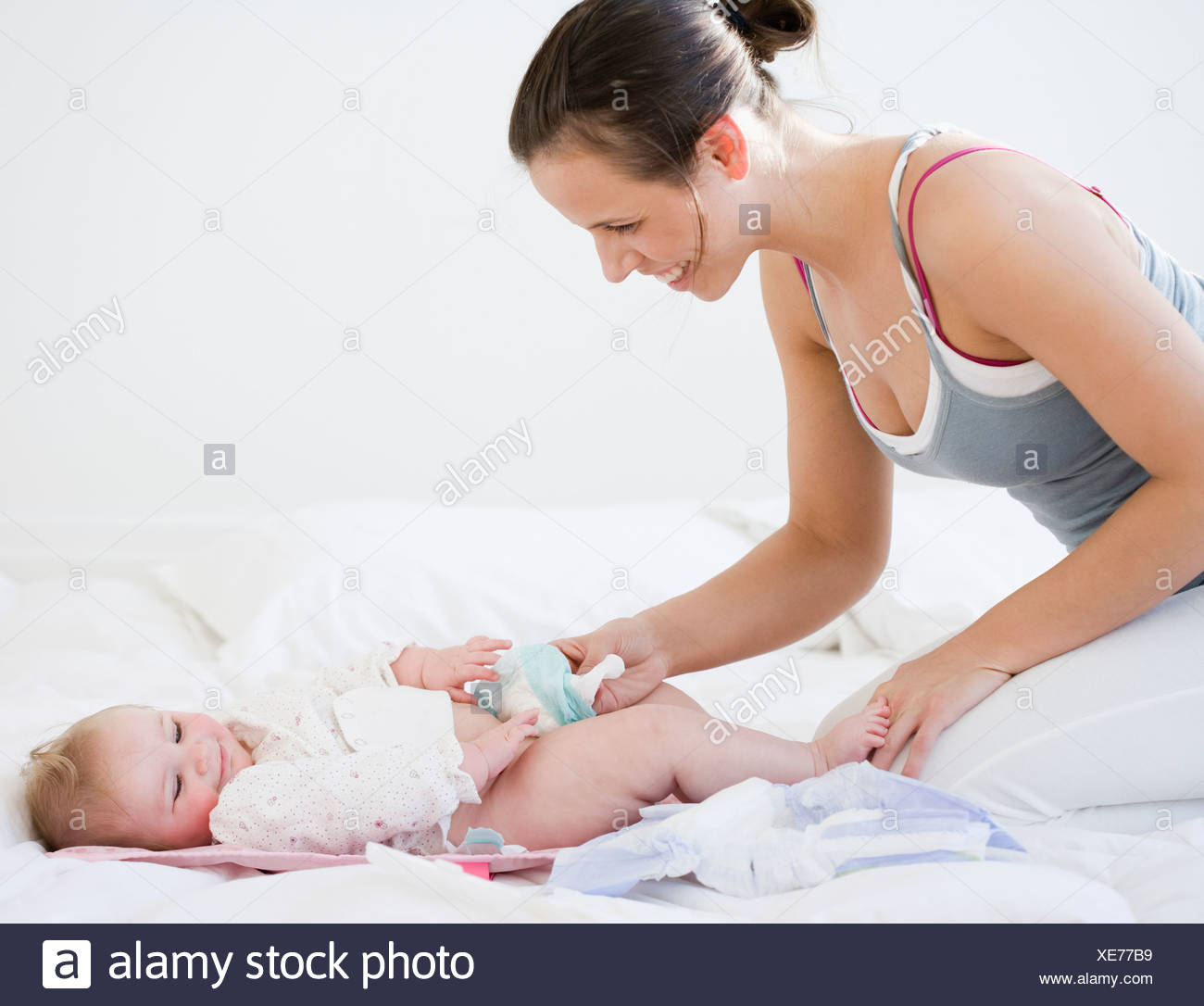 mom changing baby's diaper