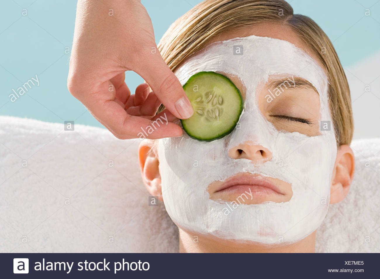 Download Young Woman Wearing Facial Mask Having Cucumber Slice Placed Over Eye Stock Photo Alamy PSD Mockup Templates