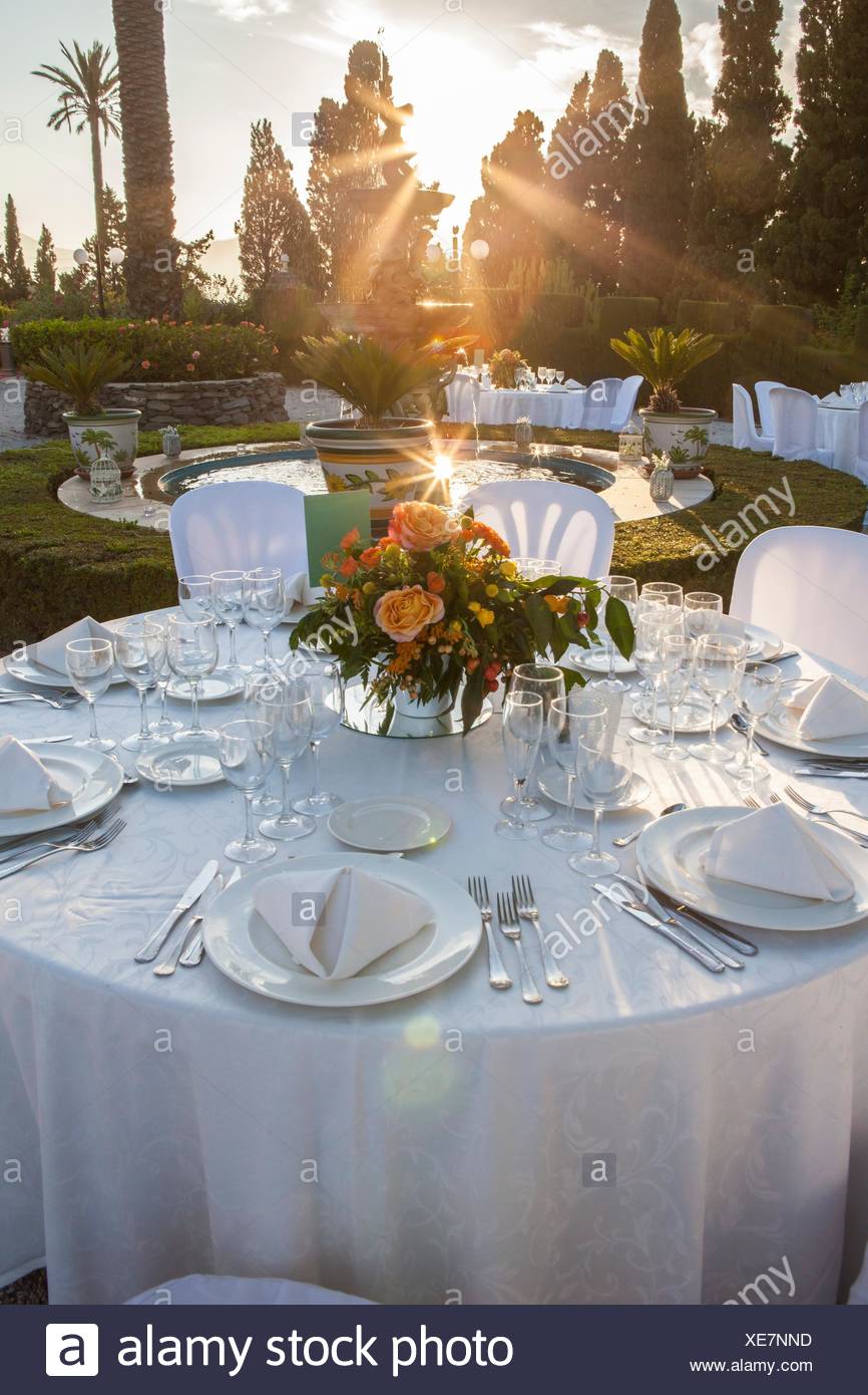 Garden Table Setting At Wedding Reception Under Sunset Sun Rays