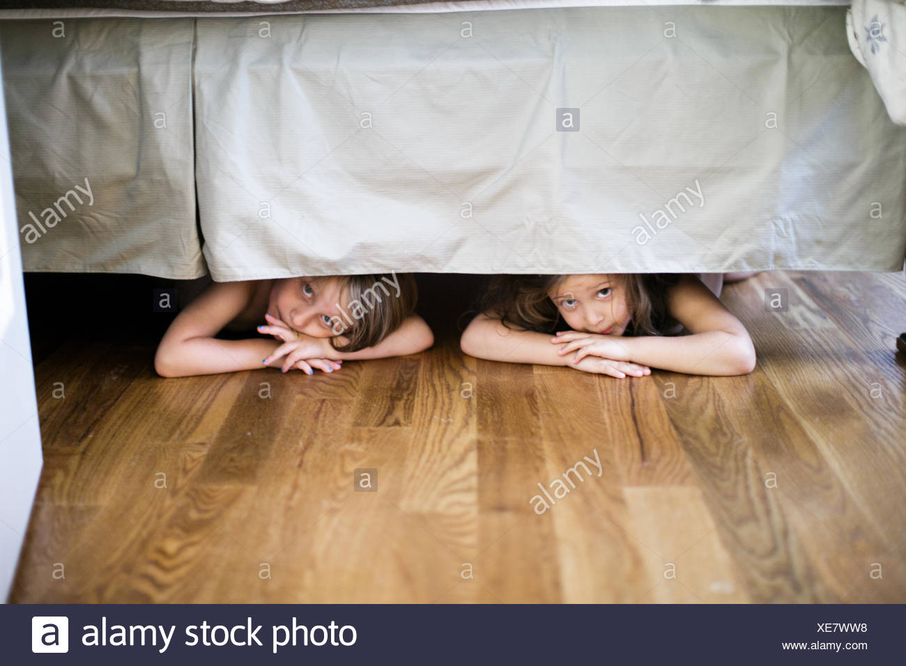 Boy And Girl Hiding Under Bed Stock Photo Alamy