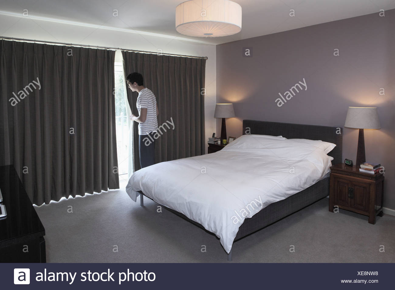 Man Peeping Behind Bedroom Curtain Stock Photo 284163860