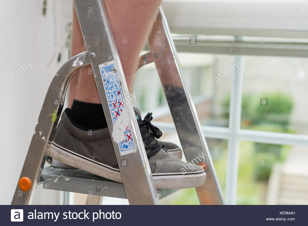 Person on a stepladder Stock Photo