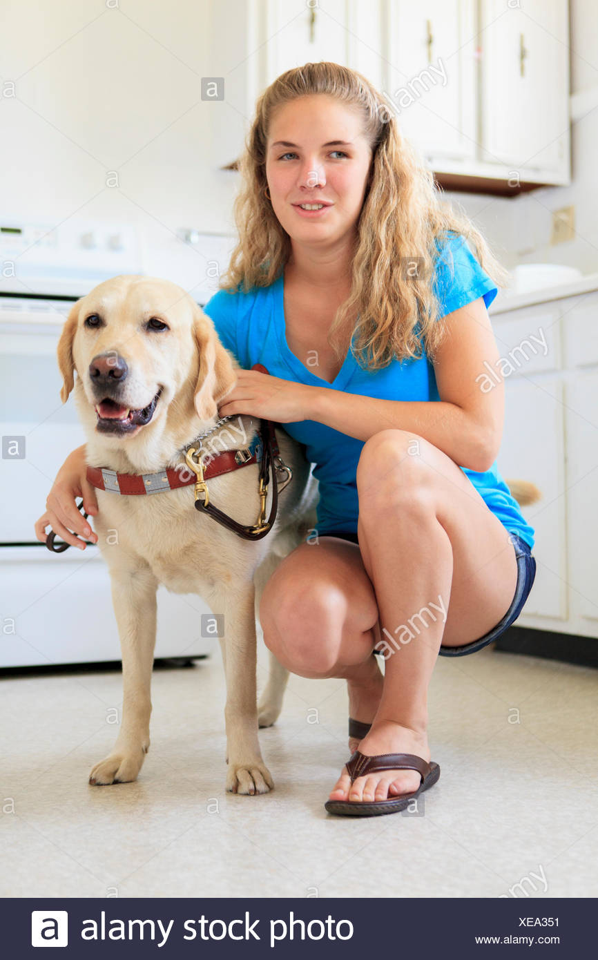 Woman with visual impairment in kitchen with her service dog Stock Photo -  Alamy