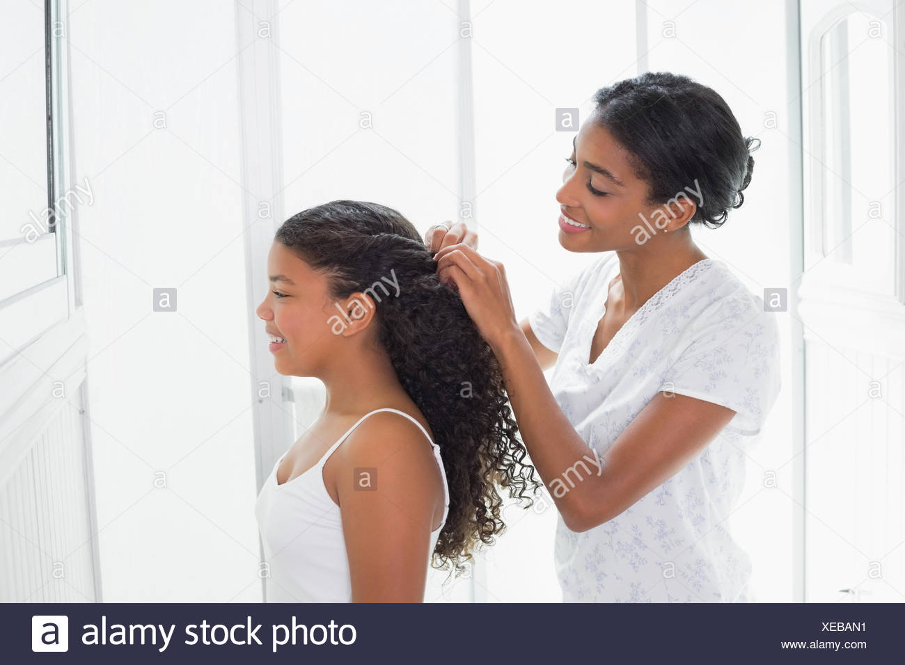 Pretty Mother Tying Her Daughters Hair Back Stock Photo 284220973