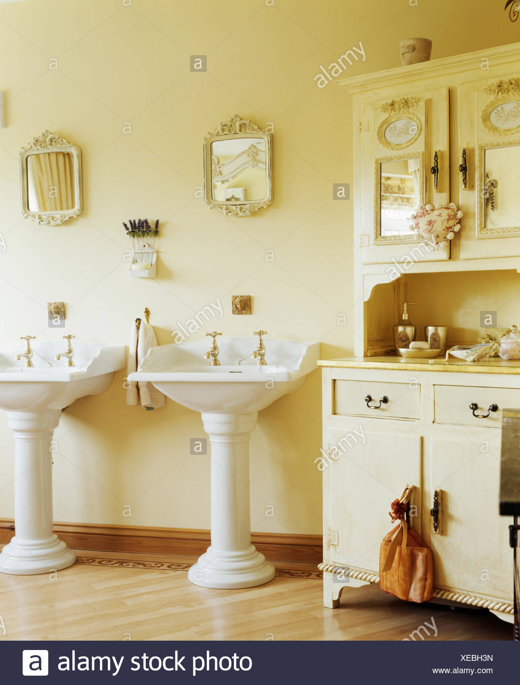 White Double Pedestal Basins In Cream Bathroom With Cream Painted