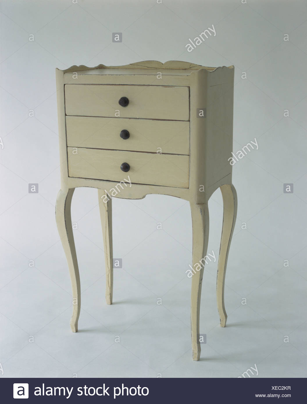 Close Up Of Painted Small Chest Of Drawers On Tall Legs Stock