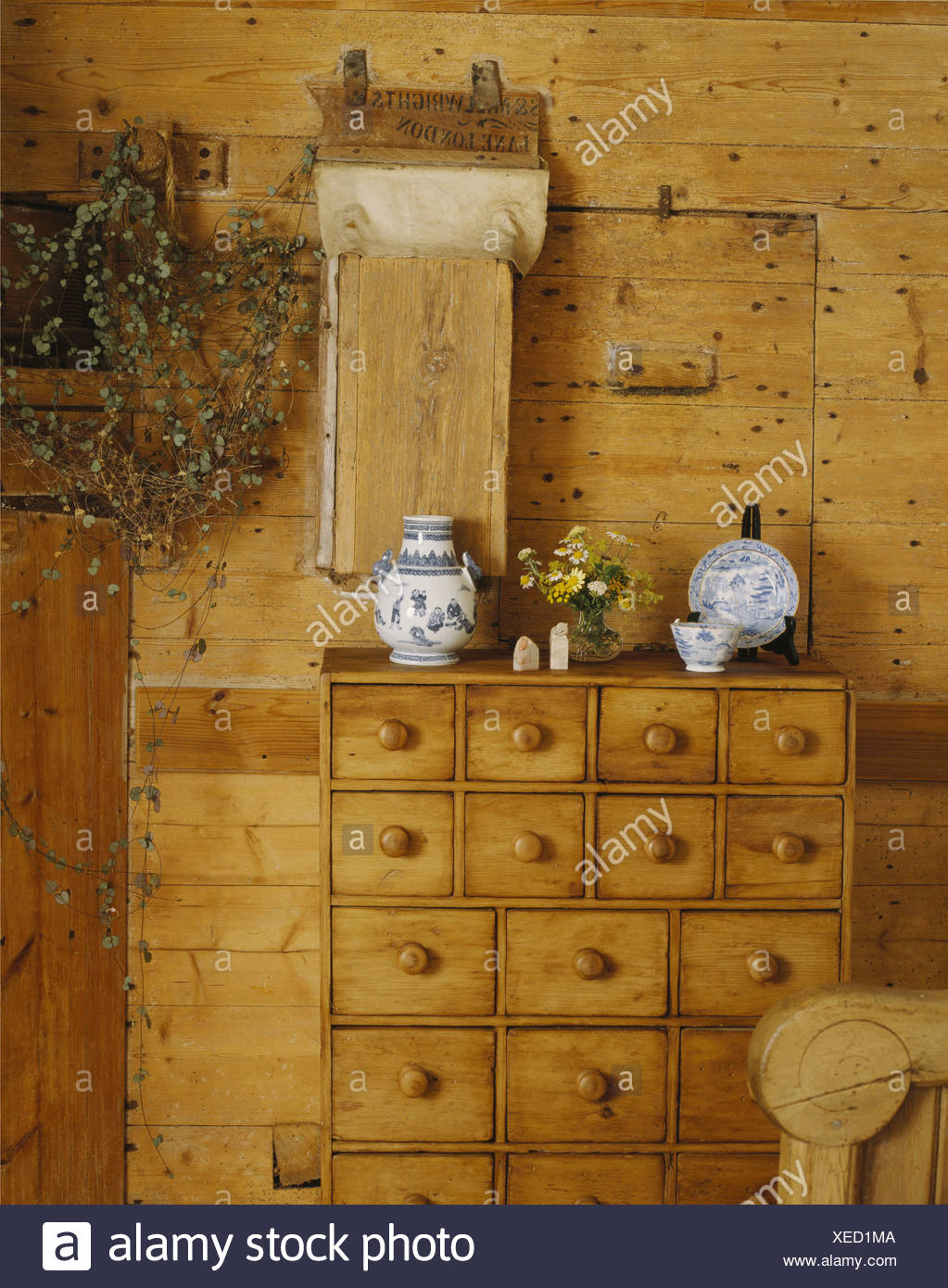 Close Up Of Pine Merchant S Chest Against Pine Paneled Wall In