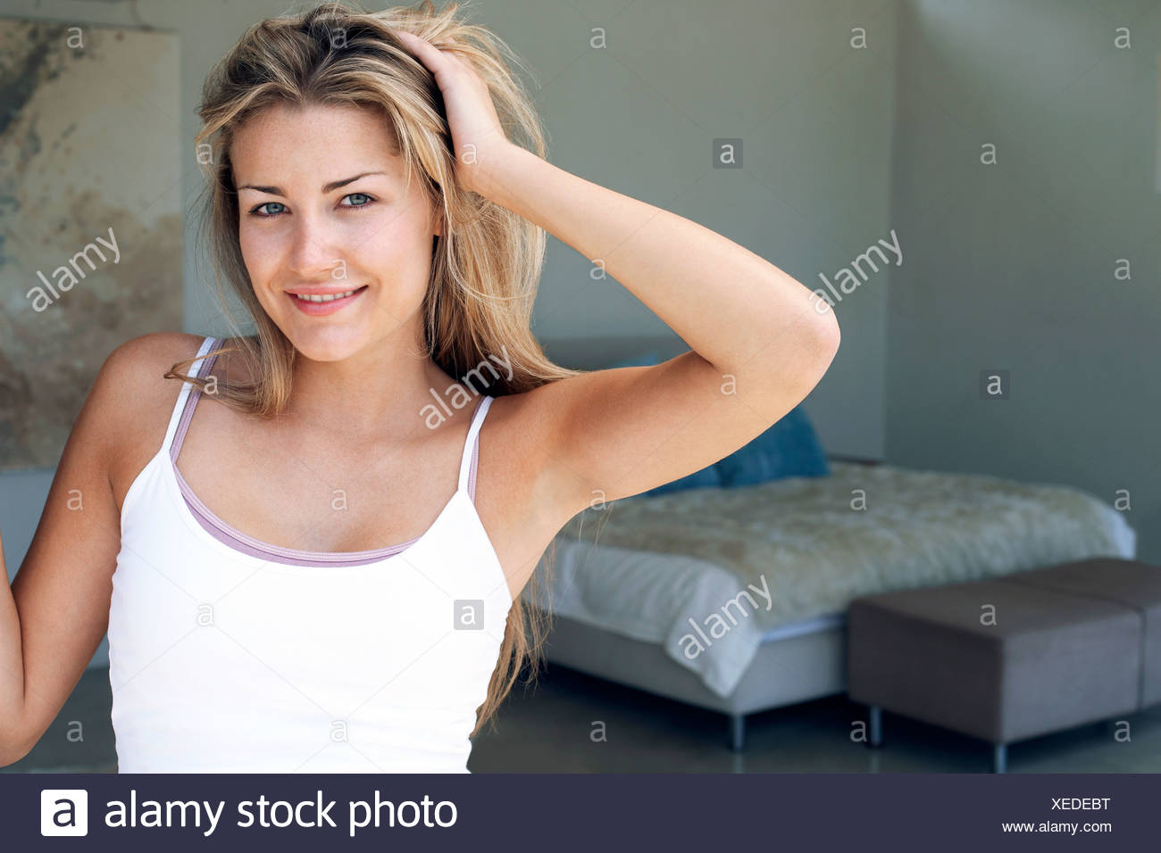 Young Man Tousling Hair Smiling Stock Photos Young Man Tousling