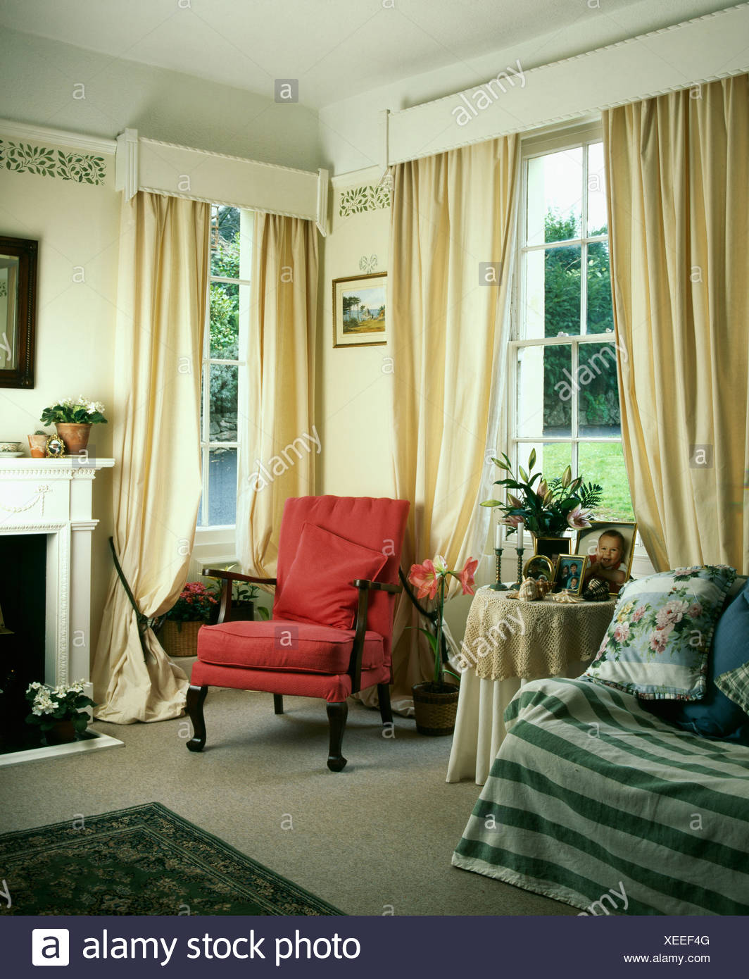 Red Armchair And Cream Curtains With White Wooden Pelmet In