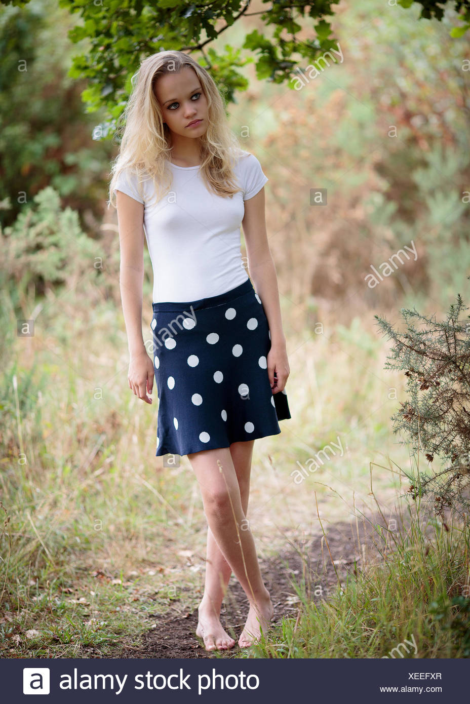 Beautiful Blond Teenage Girl Outside In The Woods Stock 