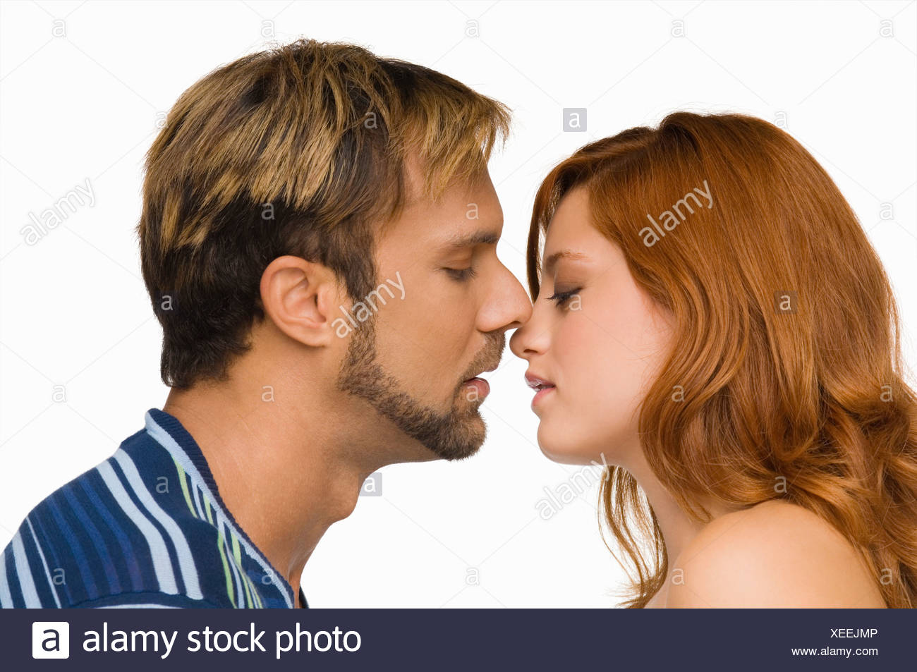 Side profile of a couple kissing each other Stock Photo - Alamy