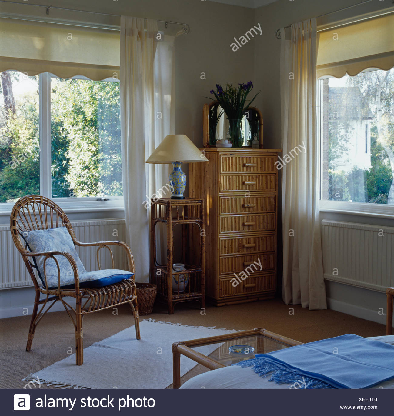 Cane Chair And Tall Chest Of Drawers In Traditional Bedroom With