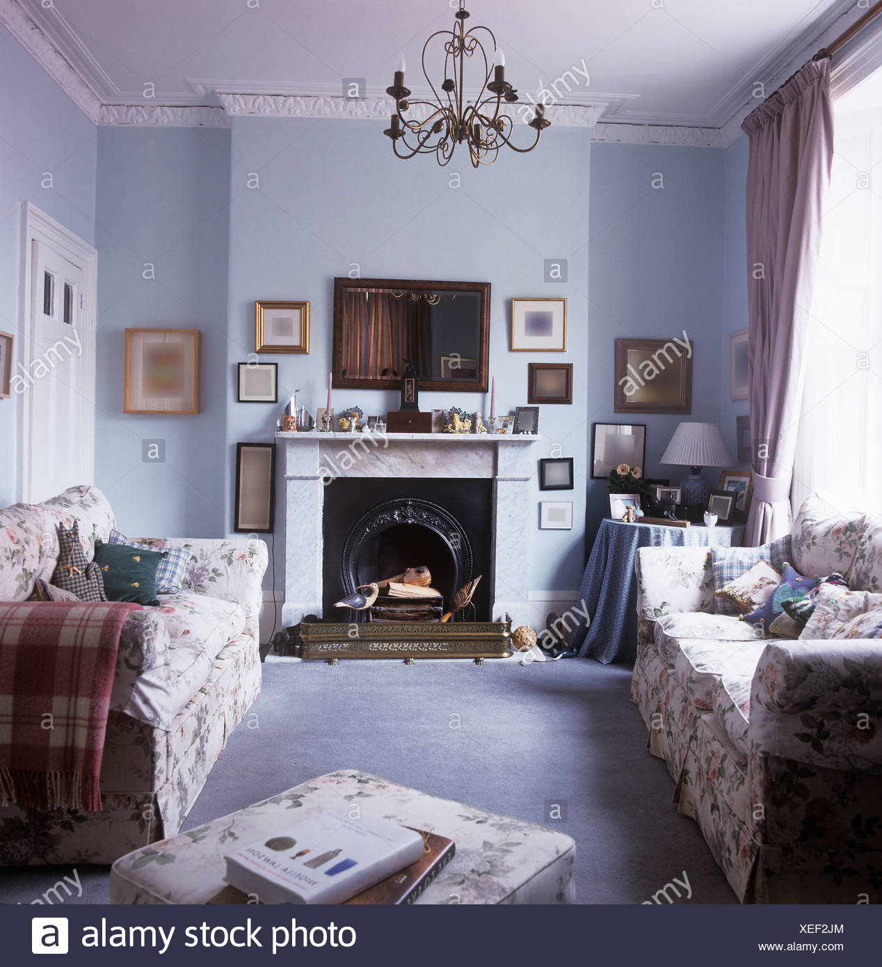 Floral Sofas On Either Side Of Marble Fireplace In Small