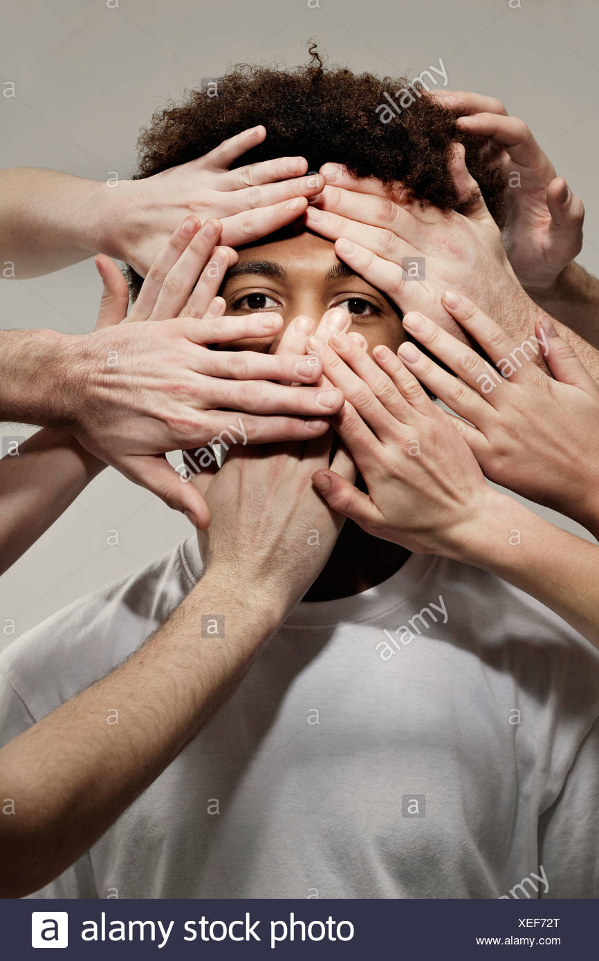 Black male hidden by hands - Stock Image