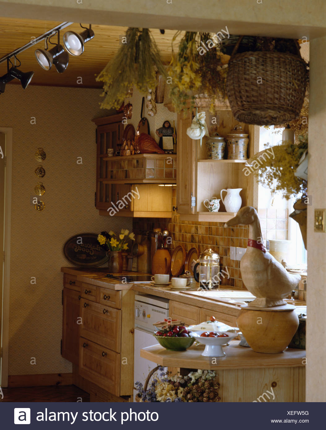 Small Cottage Kitchen With Dried Flowers On Ceiling And Spot