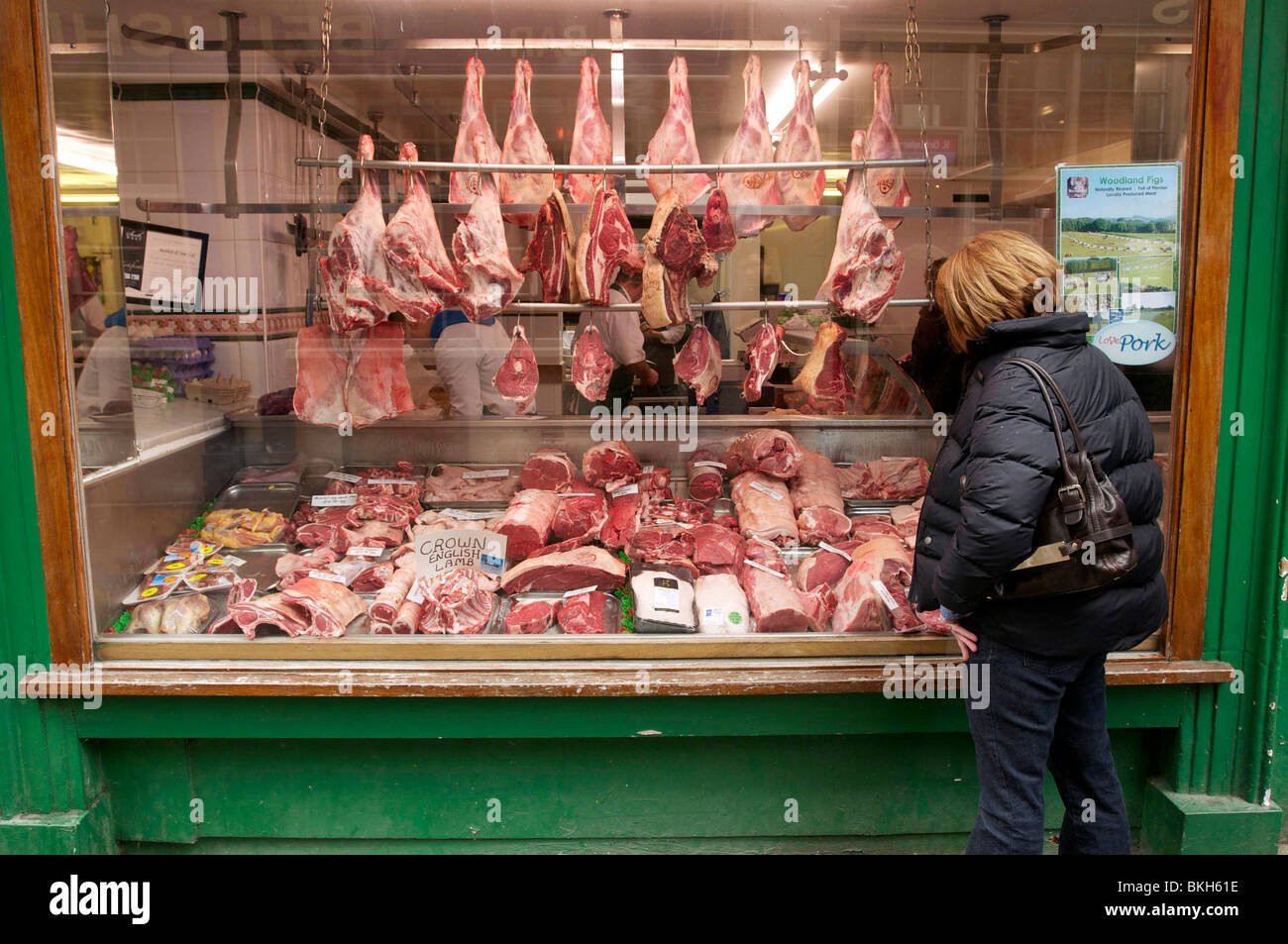 meat-hangs-on-display-in-a-traditional-butchers-shop-window-with-a-bkh61e.jpg