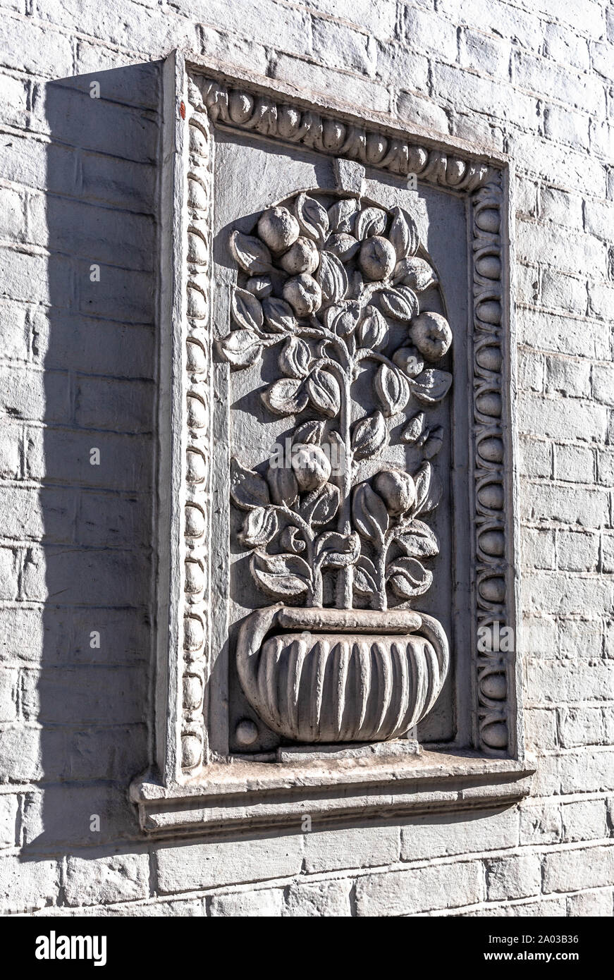 Eine gerahmte Relief einer Anlage Topf auf eine Mauer, London, England, UK. Stockfoto