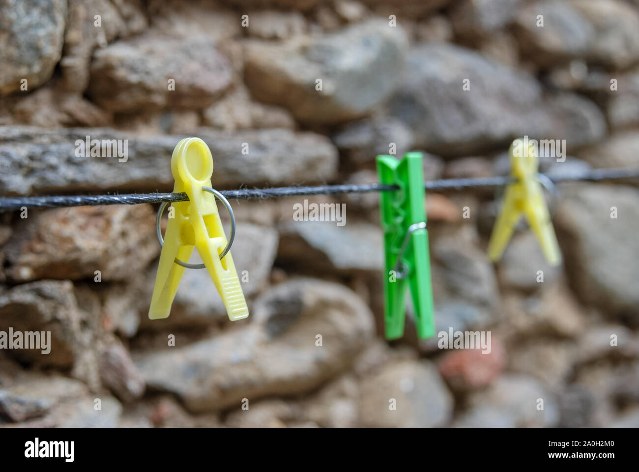 Diagonale bunten Kunststoff leer Wäscheklammern hängt das Seil im Außenbereich. Selektive konzentrieren. Stockfoto