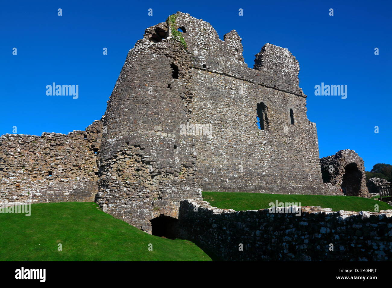 Die berühmte Ogmore Burgruine neben dem ogmore Fluss, der berühmten trittsteine der schnell fliessenden Fluss Ogmore unterhalb der Burg zu überqueren. Stockfoto