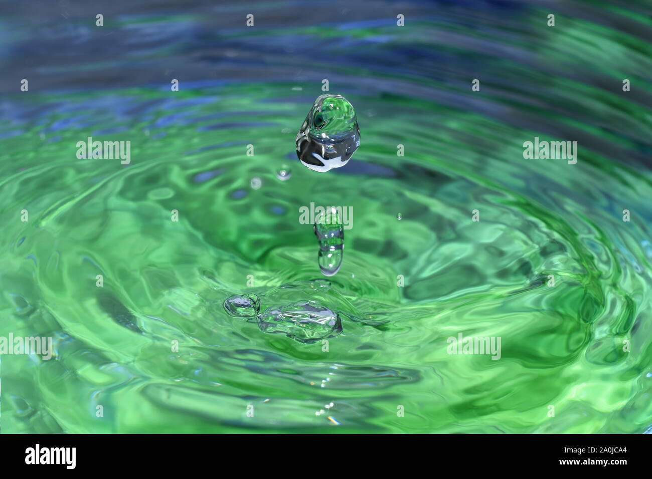 Splash und Wellen in eine grüne Flüssigkeit Stockfoto