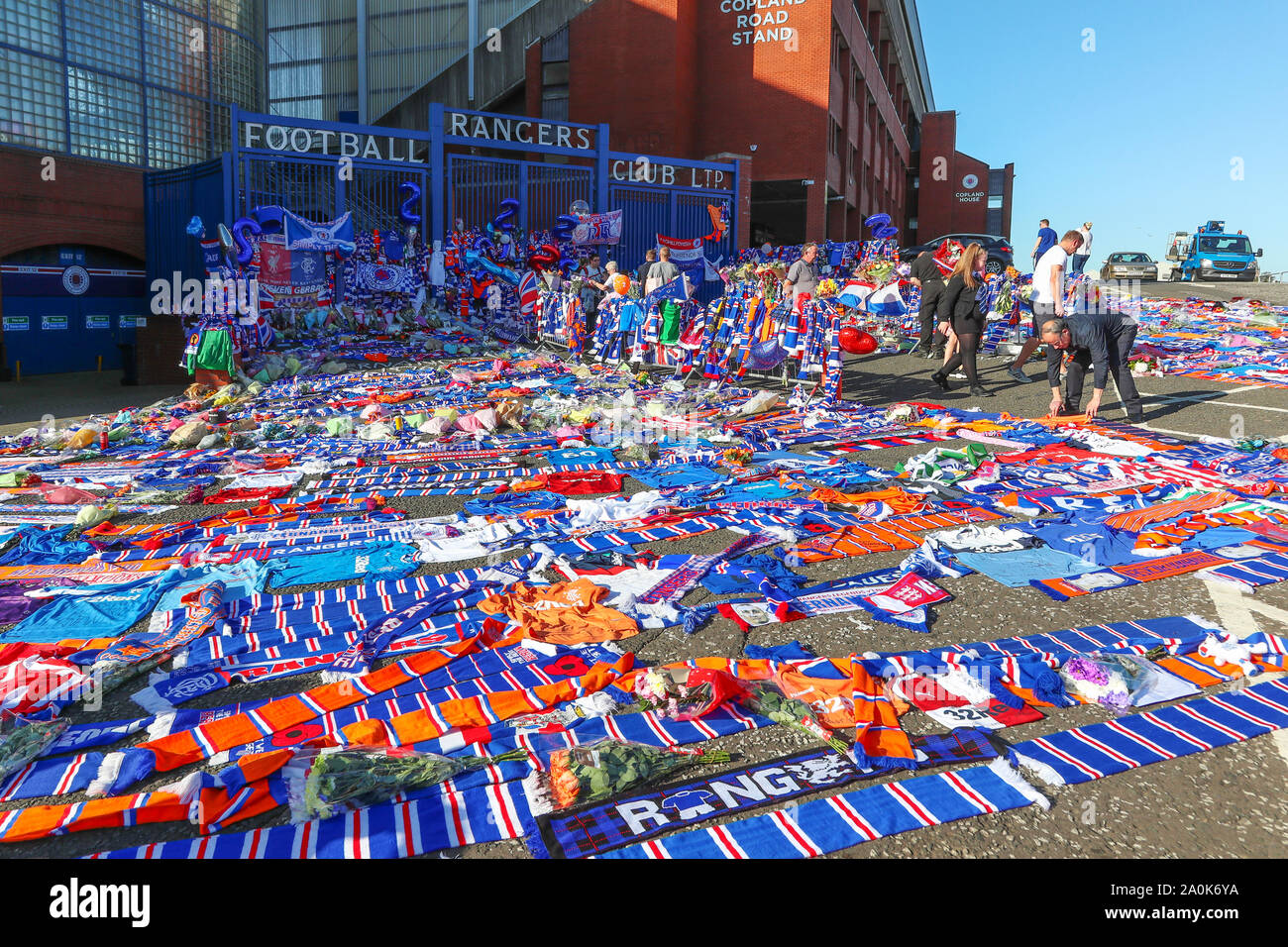 Glasgow, UK. 20 Sep, 2019. Tribute, einschließlich Blumen, Schals, Fußball, Karten und Kuchen haben an der Broomloan Straße und Copland Straße Tore von Ibrox Stadion, der Heimat der Glasgow Rangers in Respekt für FERNANDO RICKSEN, der Niederländischen internationalen Fußballer, die für Förster und der starb der Motor Neuron Disease (MND) am 18. September 2019, im Alter von 43 Links. Credit: Findlay/Alamy leben Nachrichten Stockfoto