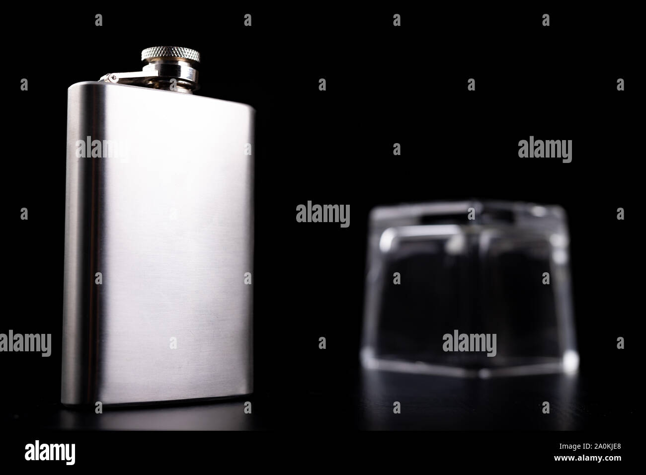 Flachmann und Glas aus dickem Glas invertiert. Barkeeper Zubehör auf dem Tisch. Schwarzen Hintergrund. Stockfoto