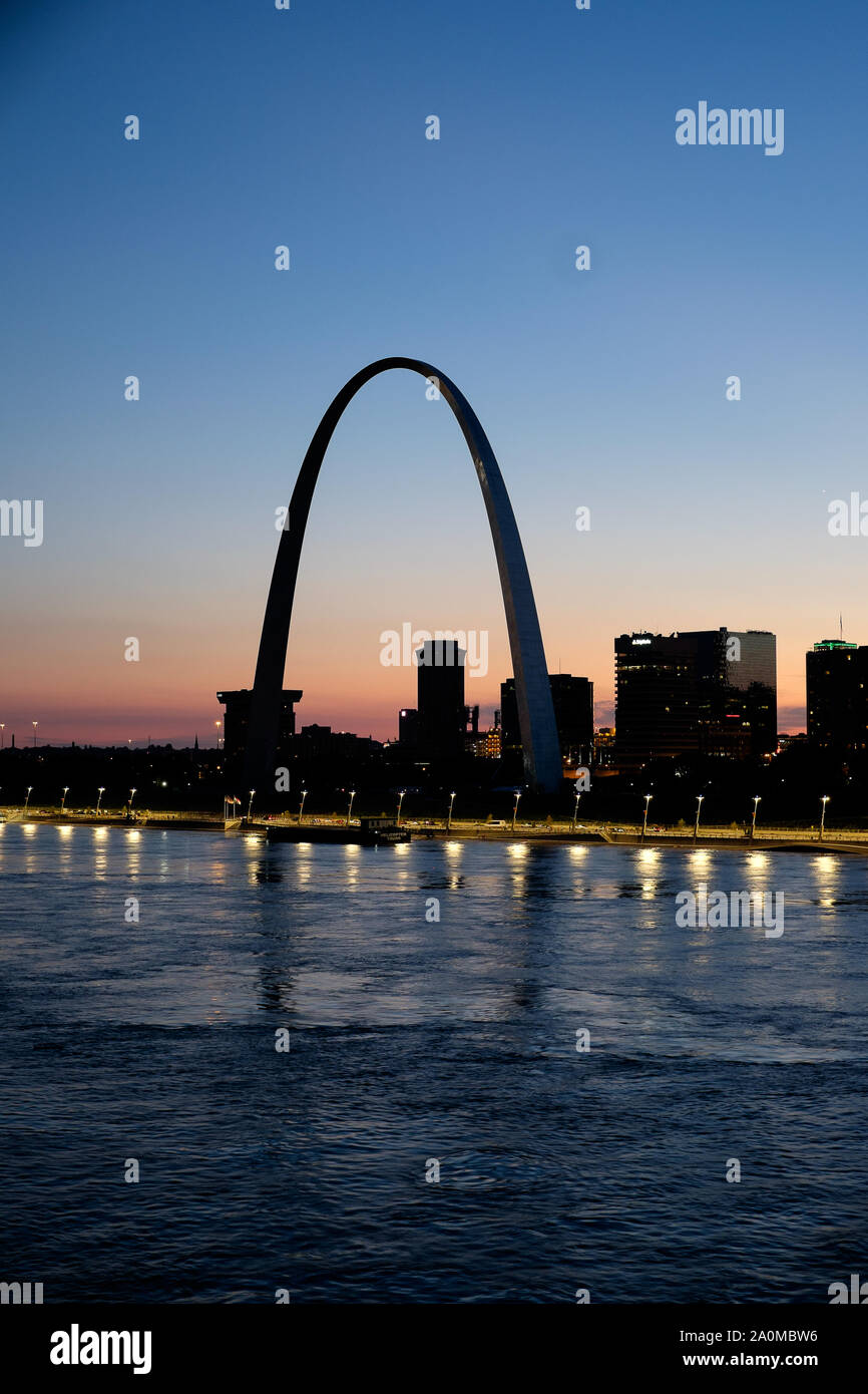 Mit der Gateway Arch, gegen einen farbenprächtigen Sonnenuntergang, die St. Louis Skyline ist über den Mississippi River aus gesehen Stockfoto